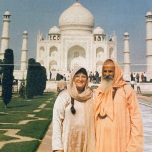 Two people standing in front of the taj mahal.